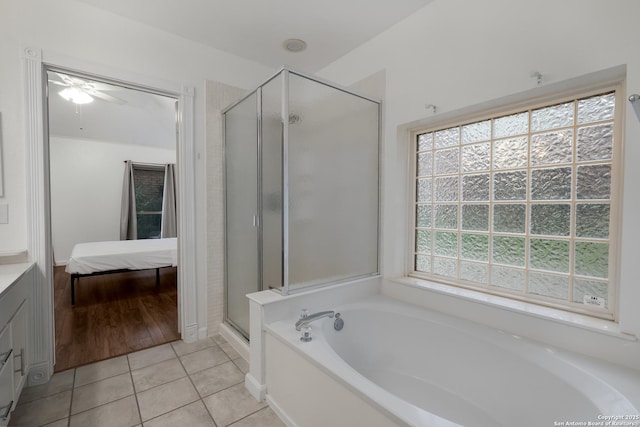 bathroom with shower with separate bathtub, tile patterned floors, and vanity