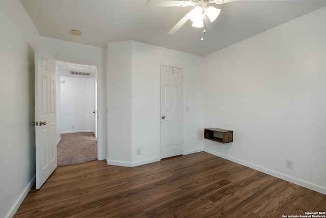 unfurnished bedroom featuring dark wood-type flooring and ceiling fan