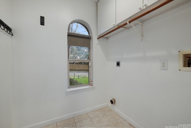 laundry room featuring cabinets, light tile patterned floors, hookup for a washing machine, and hookup for an electric dryer