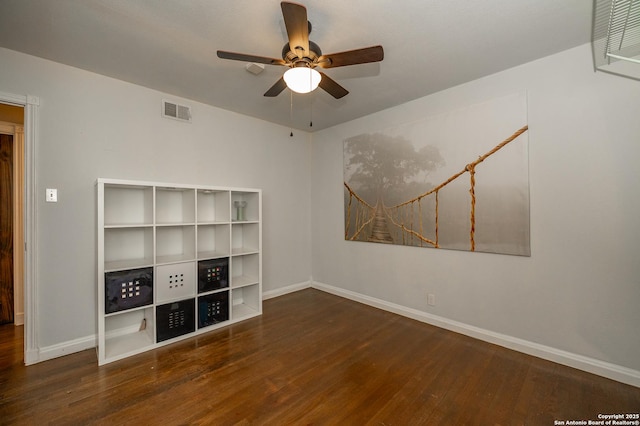 unfurnished living room with ceiling fan and dark hardwood / wood-style flooring