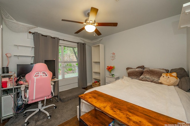 bedroom with ceiling fan and dark wood-type flooring