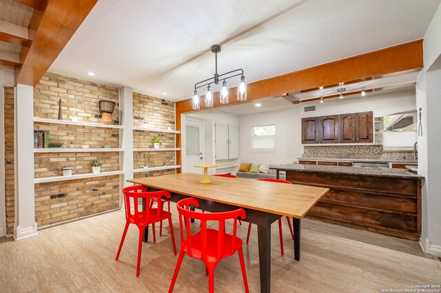 dining room with sink and brick wall