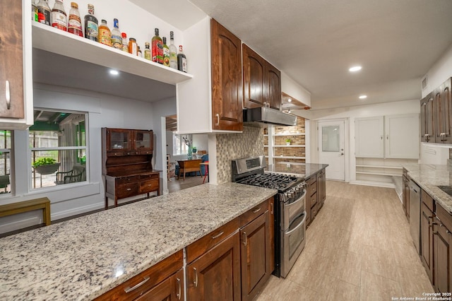 kitchen featuring stainless steel appliances, tasteful backsplash, and light stone countertops