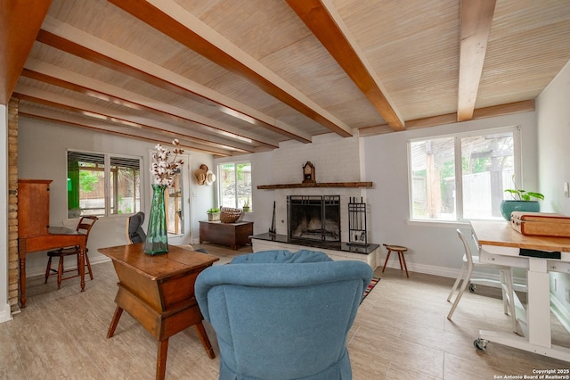 living room featuring beam ceiling, a fireplace, and wood ceiling