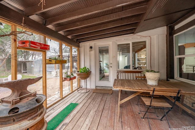 sunroom featuring beam ceiling and wood ceiling