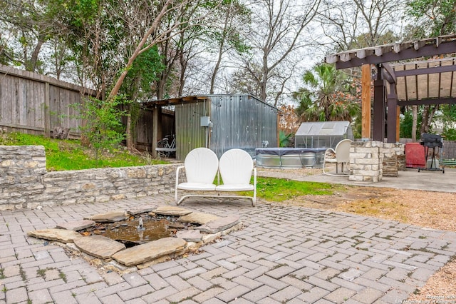 view of patio / terrace featuring a shed and area for grilling