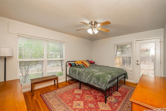 bedroom featuring access to outside, ceiling fan, and wood-type flooring