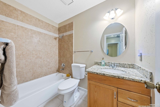 full bathroom with a textured ceiling, tiled shower / bath, tile patterned flooring, vanity, and toilet