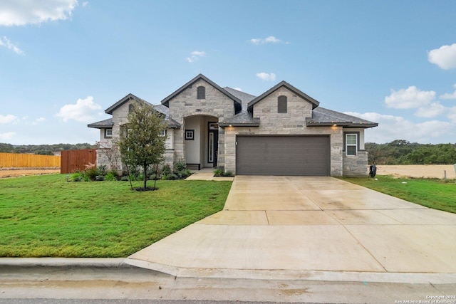 view of front facade with a front yard and a garage