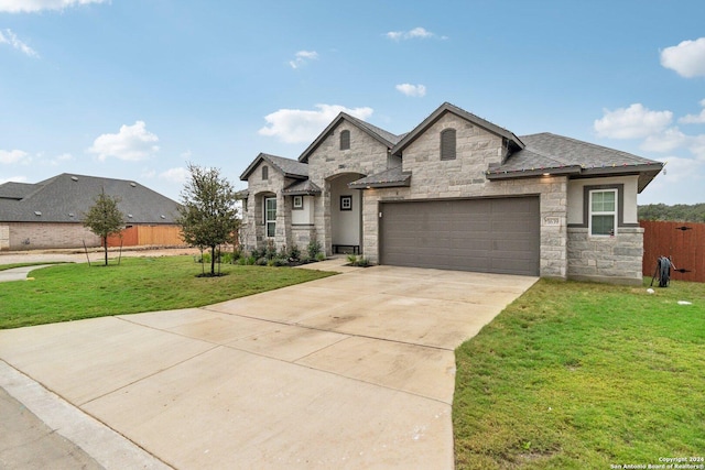 view of front of home with a front lawn and a garage