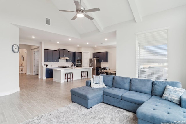 living room with beam ceiling, ceiling fan, high vaulted ceiling, and light hardwood / wood-style flooring