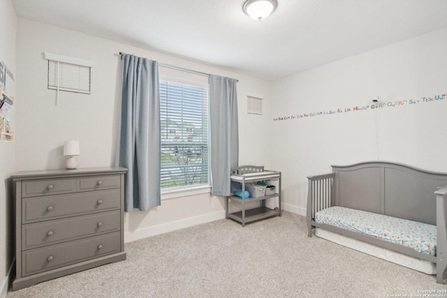 bedroom featuring light carpet