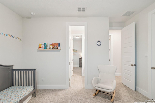 carpeted bedroom featuring a crib