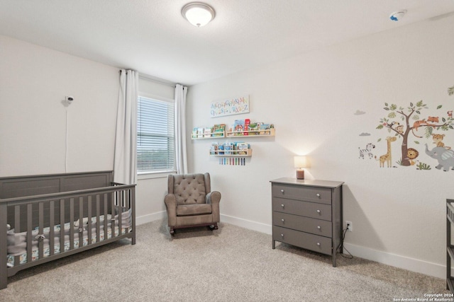 carpeted bedroom with a nursery area