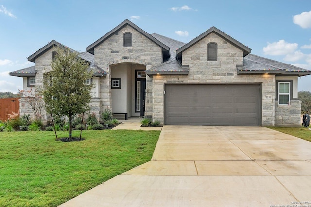 view of front facade with a front yard and a garage