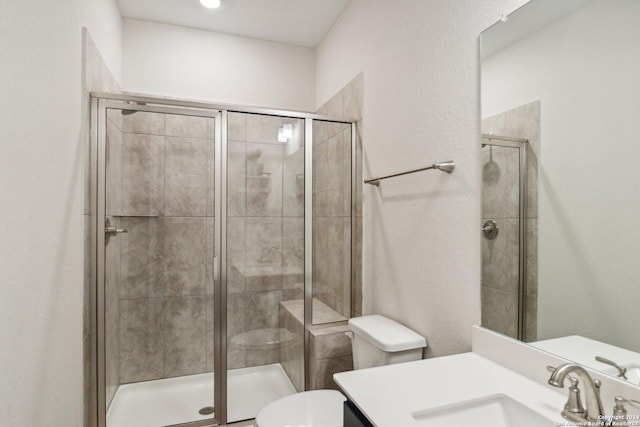 bathroom featuring toilet, walk in shower, and vanity