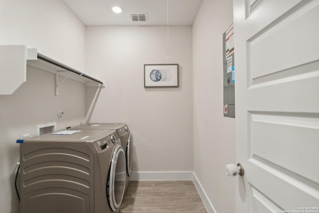 clothes washing area with washer and clothes dryer