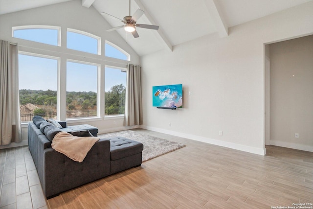 living room with beam ceiling, ceiling fan, and high vaulted ceiling