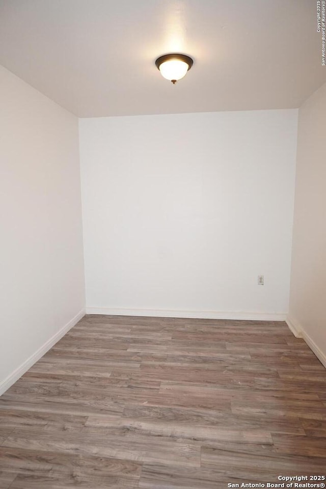 spare room with hardwood / wood-style floors