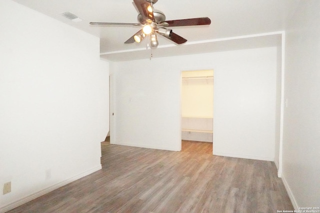 empty room featuring ceiling fan and light hardwood / wood-style floors