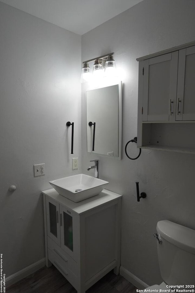 bathroom featuring toilet and vanity