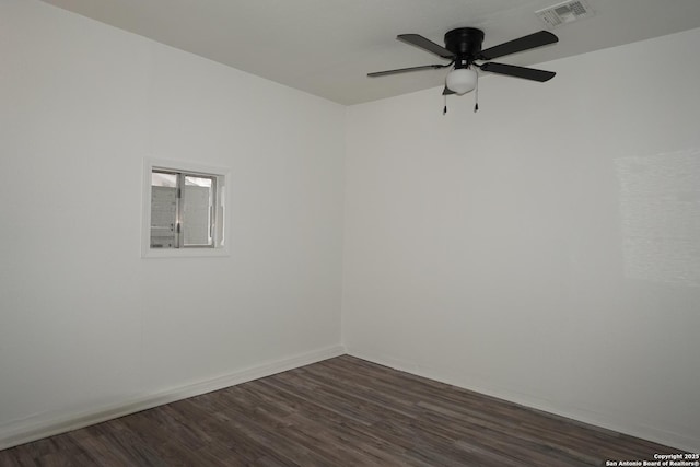 spare room with ceiling fan and dark wood-type flooring