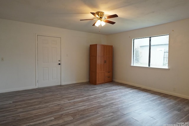 spare room featuring hardwood / wood-style flooring and ceiling fan