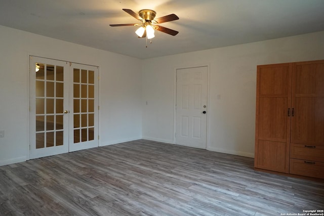 spare room with light hardwood / wood-style floors, ceiling fan, and french doors