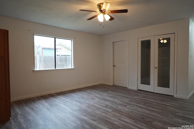 unfurnished room with french doors, ceiling fan, and hardwood / wood-style flooring