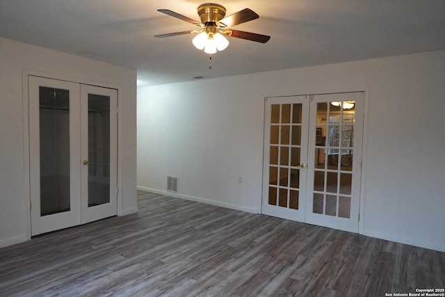 spare room featuring dark wood-type flooring, french doors, and ceiling fan