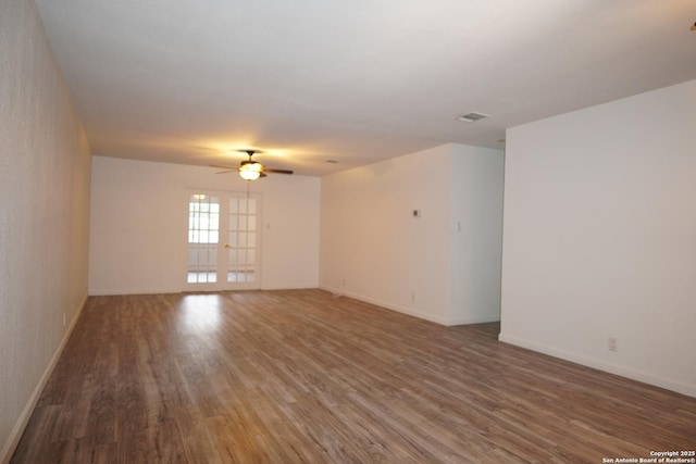 empty room featuring ceiling fan and dark hardwood / wood-style floors