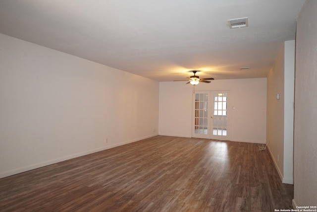 unfurnished room with ceiling fan, dark hardwood / wood-style floors, and french doors