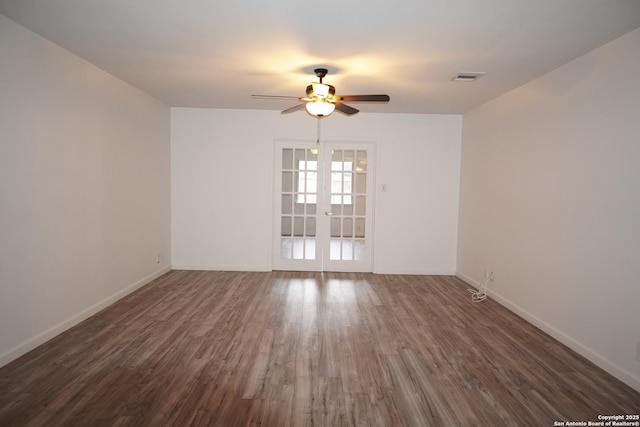 empty room featuring dark wood-type flooring, french doors, and ceiling fan