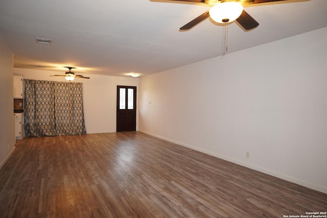 unfurnished room featuring ceiling fan and dark hardwood / wood-style floors