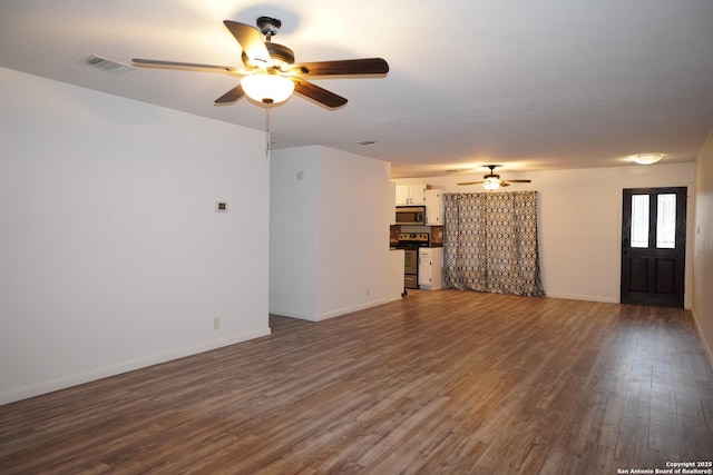 unfurnished living room featuring ceiling fan and hardwood / wood-style floors