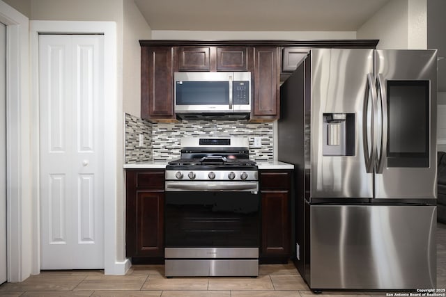 kitchen featuring tasteful backsplash, appliances with stainless steel finishes, and dark brown cabinetry