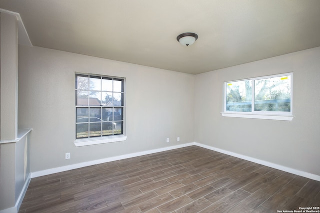 unfurnished room with dark hardwood / wood-style flooring