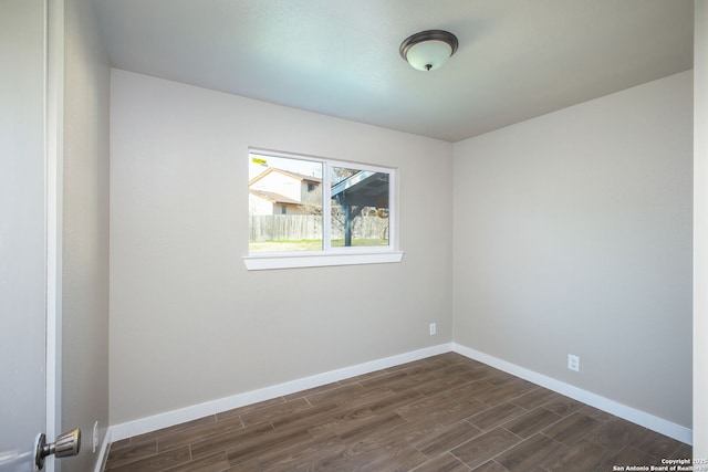 spare room featuring dark wood-type flooring