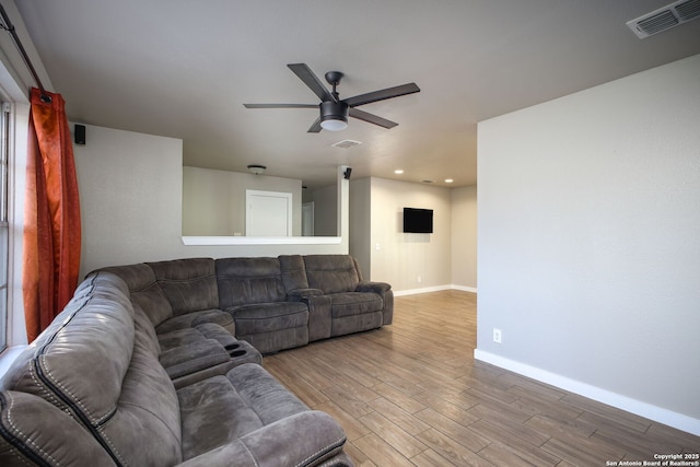 living room featuring hardwood / wood-style flooring and ceiling fan