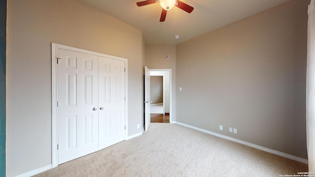 unfurnished bedroom with ceiling fan, a closet, and carpet floors