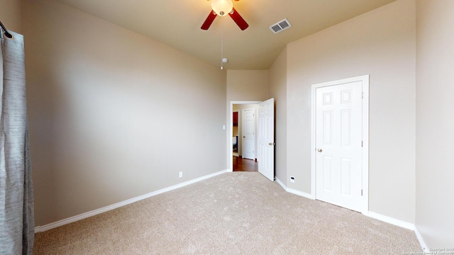 unfurnished bedroom featuring ceiling fan and light colored carpet