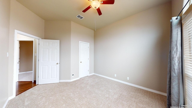 unfurnished bedroom featuring ceiling fan, carpet, and a closet