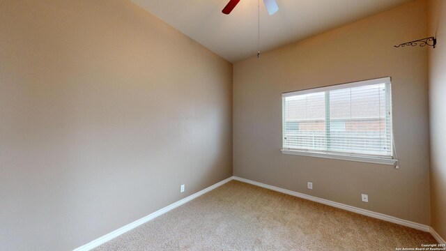 unfurnished room with ceiling fan, vaulted ceiling, and carpet flooring