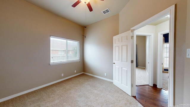 carpeted spare room with ceiling fan