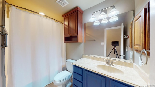 bathroom featuring toilet and vanity