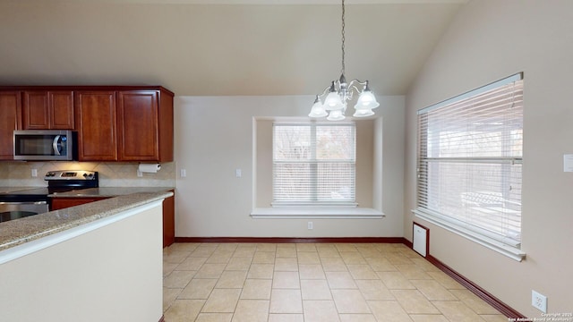 kitchen featuring stainless steel appliances, decorative backsplash, plenty of natural light, lofted ceiling, and hanging light fixtures