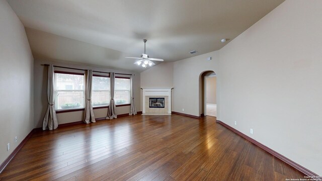 unfurnished living room with ceiling fan, dark wood-type flooring, and lofted ceiling