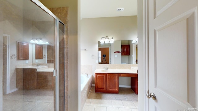 bathroom with vanity, tile patterned flooring, and plus walk in shower