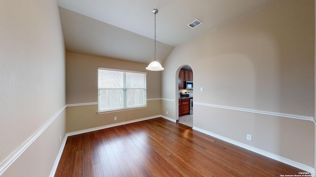 unfurnished dining area with vaulted ceiling and dark hardwood / wood-style floors