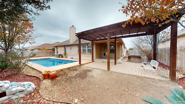 view of swimming pool featuring a pergola, exterior kitchen, and a patio